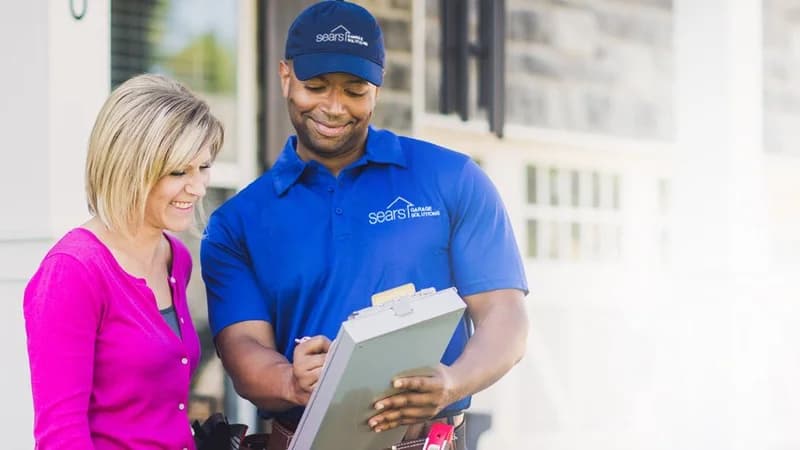 Sears Home Services technician consulting with customer in 2010